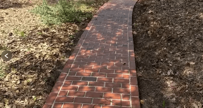 Clean curved red brick walkway with crisp mortar joints