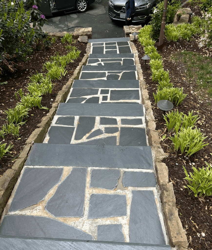Clean flagstone steps with light mortar joints and landscaped borders